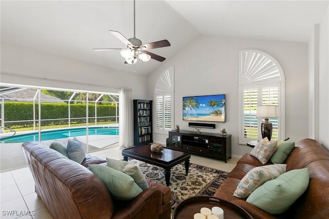 tiled living room with ceiling fan and lofted ceiling