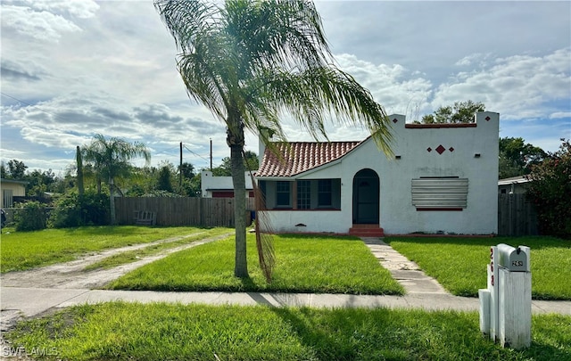 mediterranean / spanish-style home featuring a front lawn