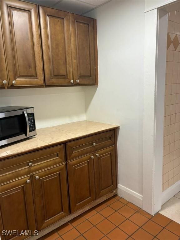 kitchen featuring tile countertops and light tile patterned floors