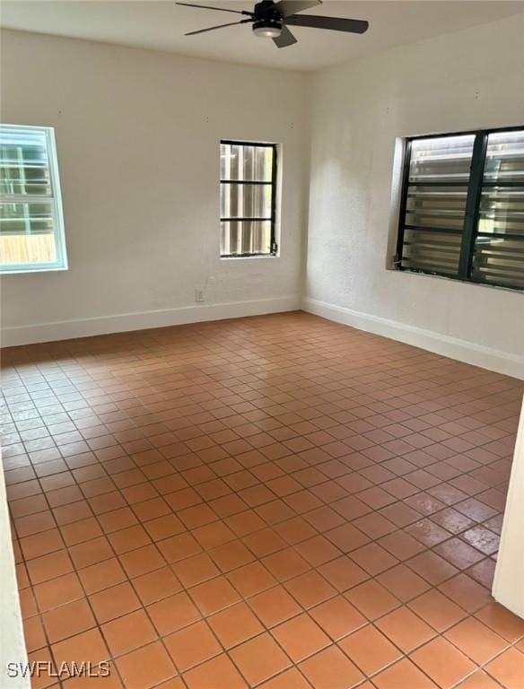 tiled empty room with ceiling fan