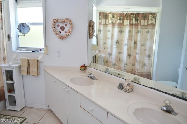 bathroom featuring tile patterned flooring and vanity