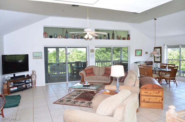 living room with light tile patterned floors, plenty of natural light, and ceiling fan