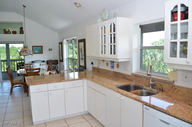 kitchen with kitchen peninsula, dishwasher, vaulted ceiling, and a healthy amount of sunlight