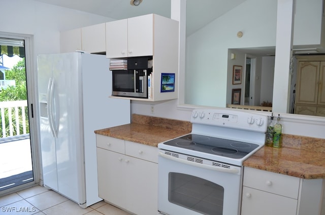 kitchen with lofted ceiling, white cabinetry, white appliances, and light tile patterned floors