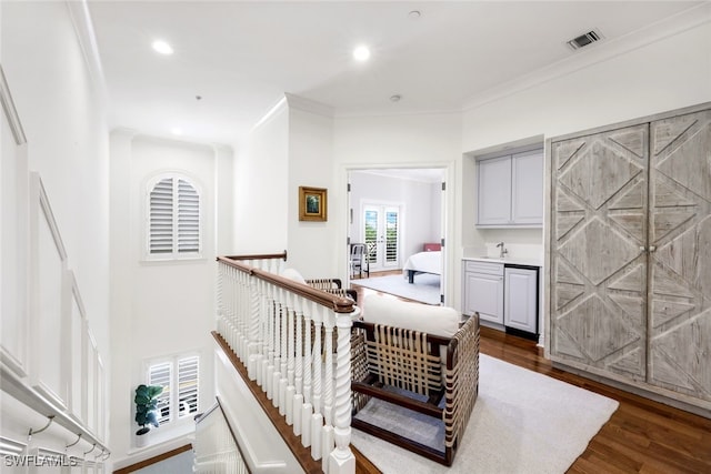 hall featuring dark hardwood / wood-style flooring and crown molding