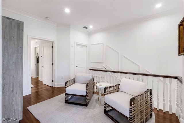 living area with dark hardwood / wood-style floors and ornamental molding