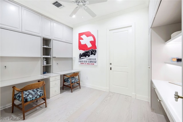 office with ceiling fan and light hardwood / wood-style flooring