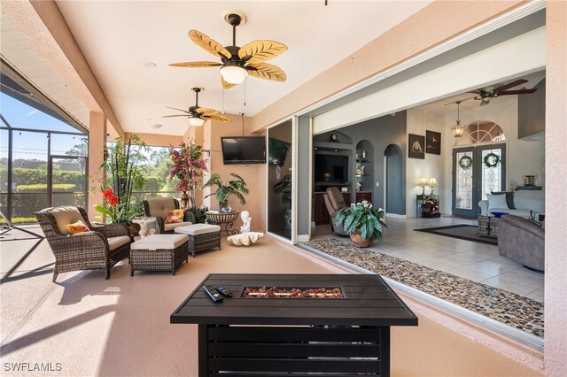 exterior space featuring an outdoor living space with a fire pit and glass enclosure