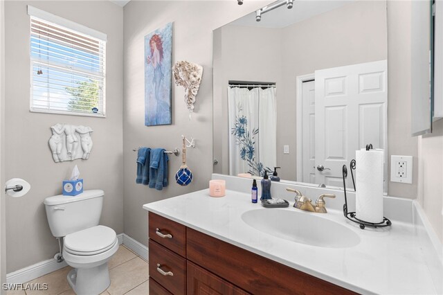 bathroom with tile patterned flooring, vanity, a shower with curtain, and toilet