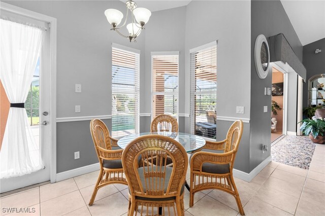 dining room featuring light tile patterned flooring and an inviting chandelier