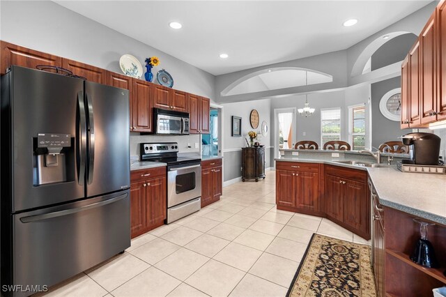 kitchen featuring sink, an inviting chandelier, decorative light fixtures, light tile patterned floors, and stainless steel appliances