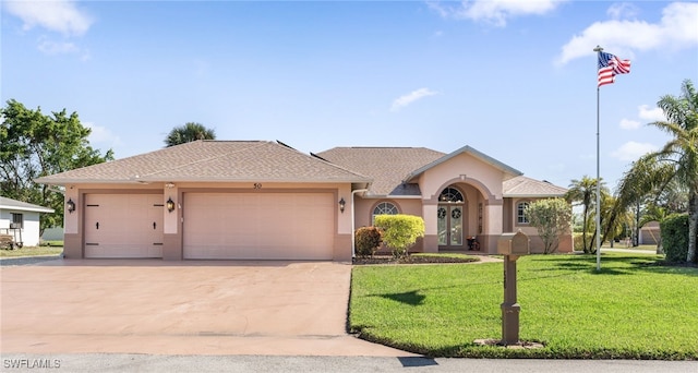 ranch-style home featuring a front lawn and a garage