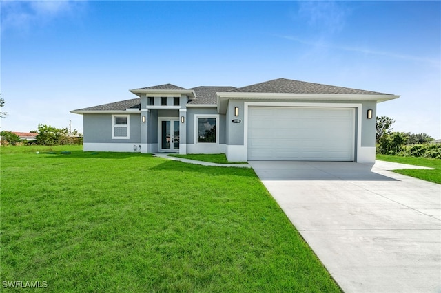 prairie-style house featuring a front lawn, french doors, and a garage