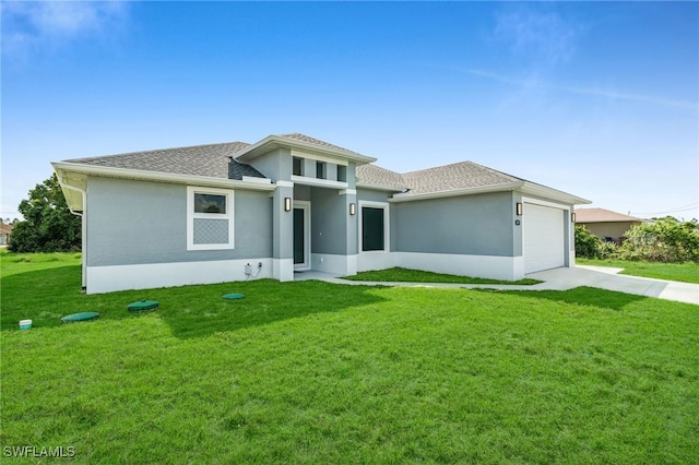 prairie-style house featuring a garage and a front yard