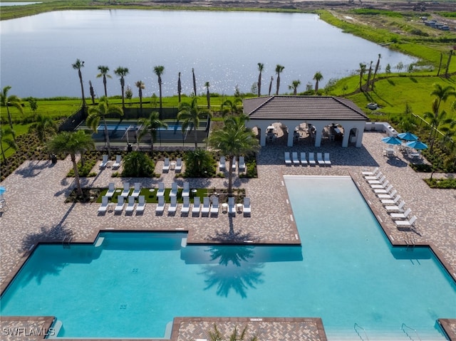 view of swimming pool featuring a water view