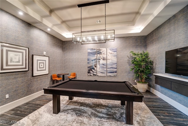 game room with ornamental molding, dark wood-type flooring, billiards, and a tray ceiling