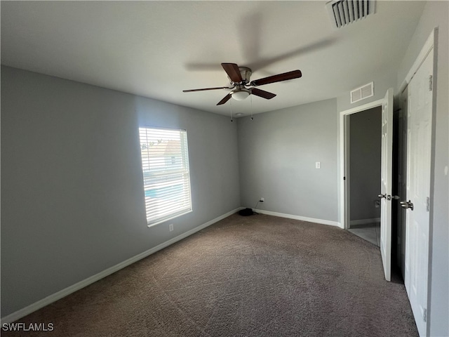 carpeted empty room featuring ceiling fan