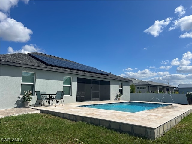 view of swimming pool featuring pool water feature and a patio