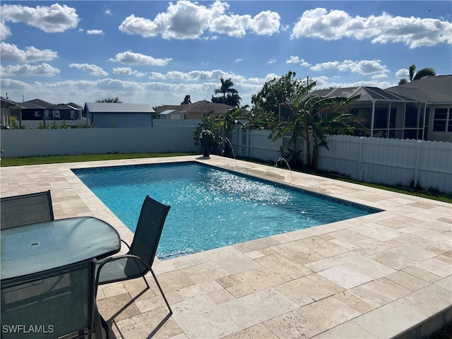 view of pool with pool water feature and a patio