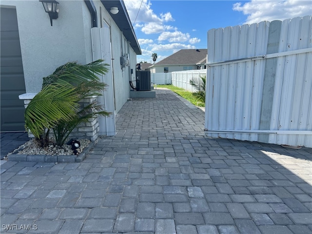 view of property exterior featuring central AC unit and a patio area