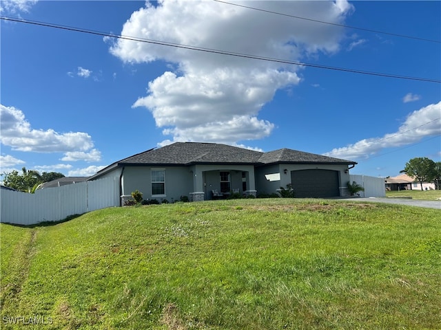 view of front facade with a front yard and a garage