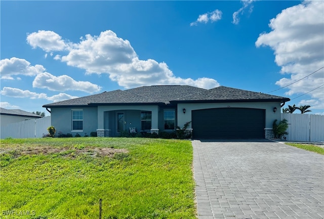 view of front of property featuring a garage and a front lawn