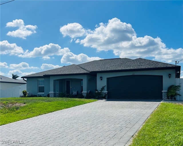 view of front facade featuring a front lawn and a garage