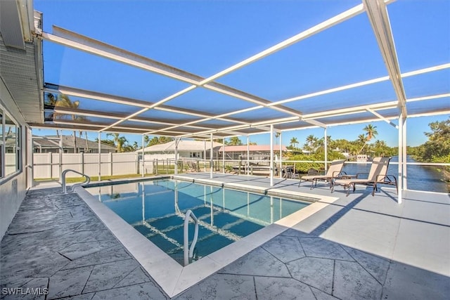 view of pool with glass enclosure and a patio