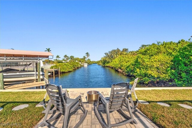 dock area featuring a lawn and a water view