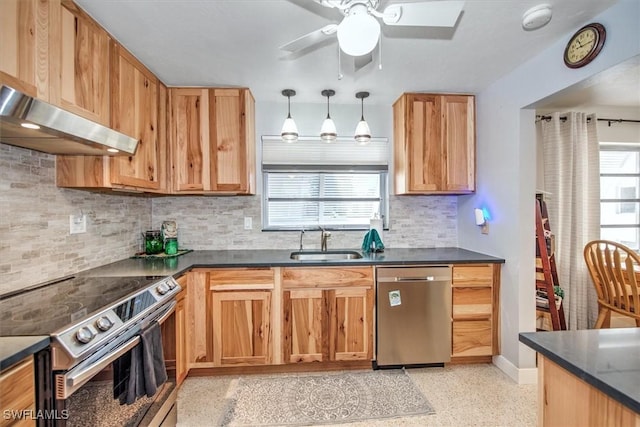 kitchen featuring appliances with stainless steel finishes, backsplash, decorative light fixtures, and sink