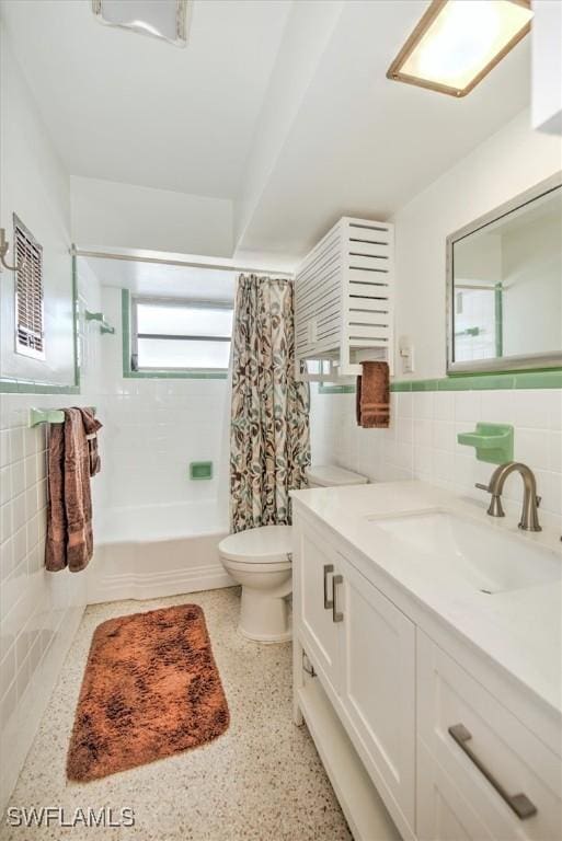 full bathroom with vanity, toilet, tile walls, tasteful backsplash, and shower / tub combo