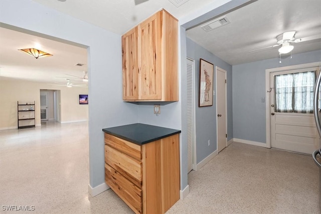 349 Coral Dr, Fort Myers, FL 33905 - kitchen featuring ceiling fan, light brown cabinetry, dark speckled floor, and baseboards