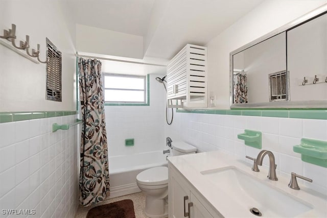 349 Coral Dr, Fort Myers, FL 33905 - bathroom featuring tile walls, toilet, vanity, shower / bath combo, and wainscoting