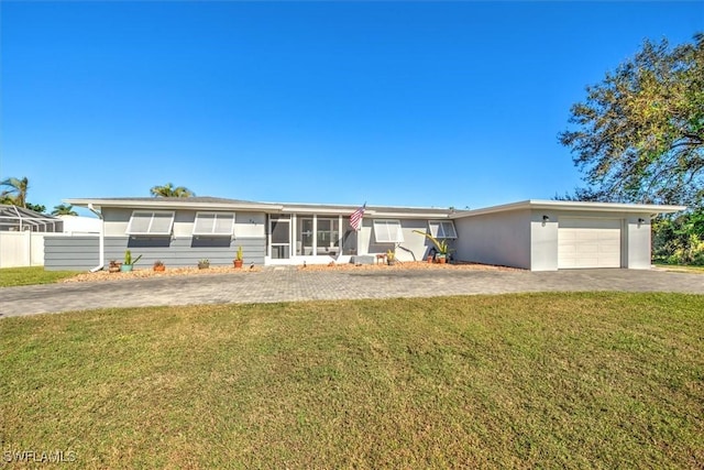 349 Coral Dr, Fort Myers, FL 33905 - ranch-style home with driveway, a garage, a front yard, and a sunroom