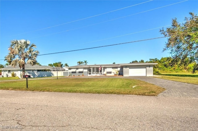 349 Coral Dr, Fort Myers, FL 33905 - ranch-style home with a garage, asphalt driveway, and a front lawn