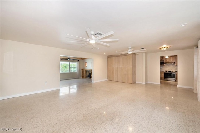 349 Coral Dr, Fort Myers, FL 33905 - unfurnished living room featuring a fireplace, ceiling fan, baseboards, and dark aggregate flooring