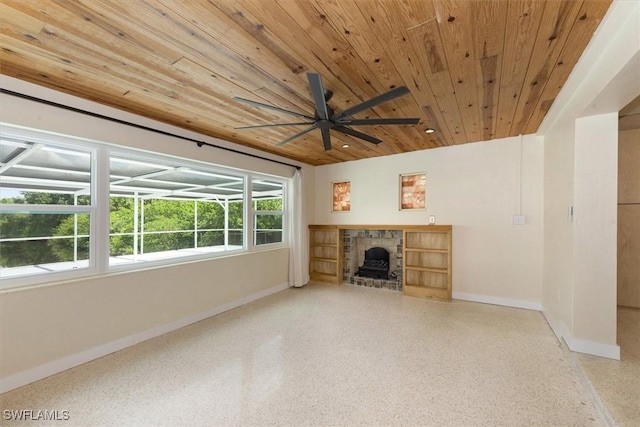 349 Coral Dr, Fort Myers, FL 33905 - unfurnished living room featuring baseboards, wood ceiling, a ceiling fan, speckled floor, and a fireplace