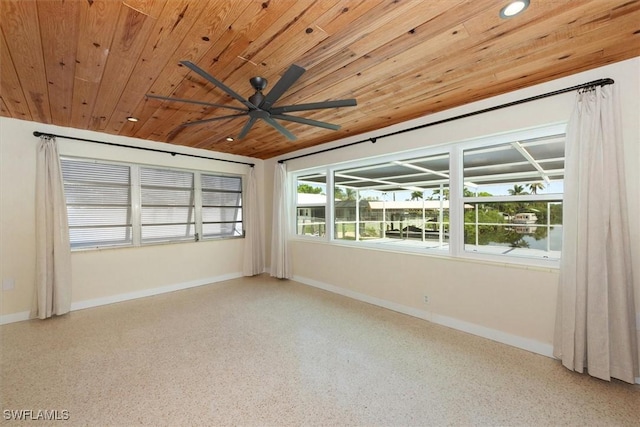 349 Coral Dr, Fort Myers, FL 33905 - spare room featuring wood ceiling, speckled floor, a ceiling fan, and baseboards