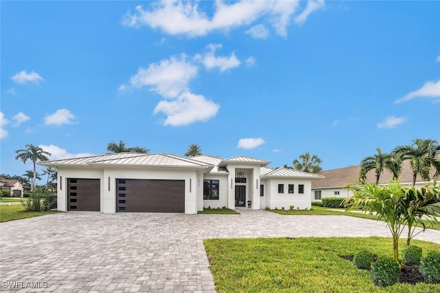 view of front of house with a front yard and a garage