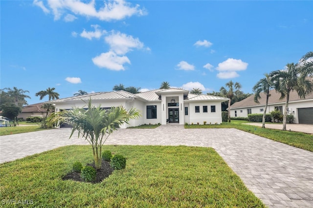 view of front of property with a garage and a front yard