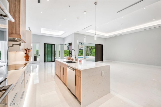 kitchen with light brown cabinets, sink, hanging light fixtures, stainless steel dishwasher, and an island with sink