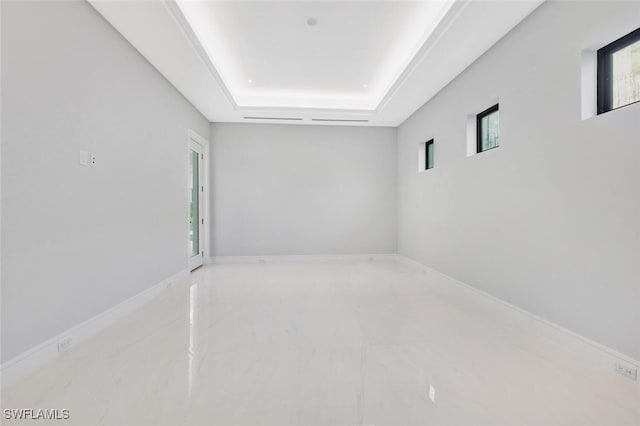 unfurnished room with a raised ceiling