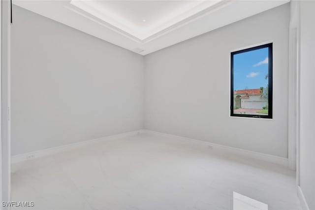 unfurnished room with a tray ceiling