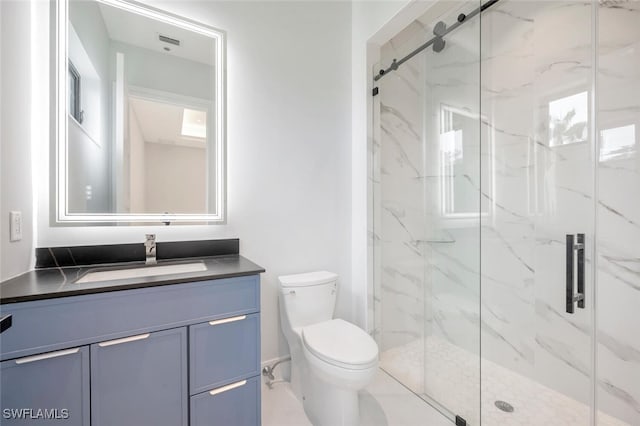 bathroom featuring vanity, an enclosed shower, and toilet