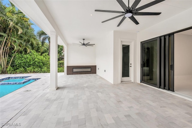 view of patio with an in ground hot tub