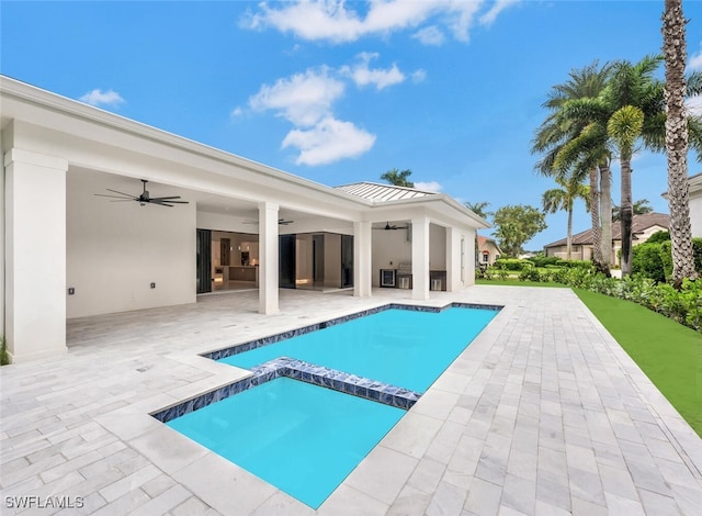 view of swimming pool featuring ceiling fan, an in ground hot tub, and a patio