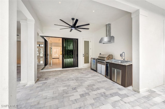 interior space featuring sink, an outdoor kitchen, ceiling fan, and a grill