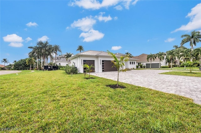 ranch-style house with a front lawn and a garage