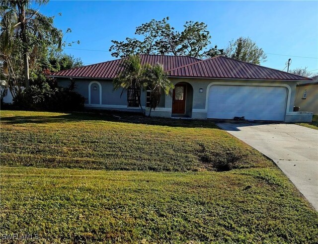 view of front of home with a front yard and a garage