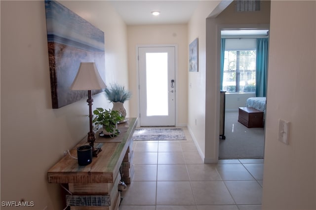 doorway to outside featuring light tile patterned floors